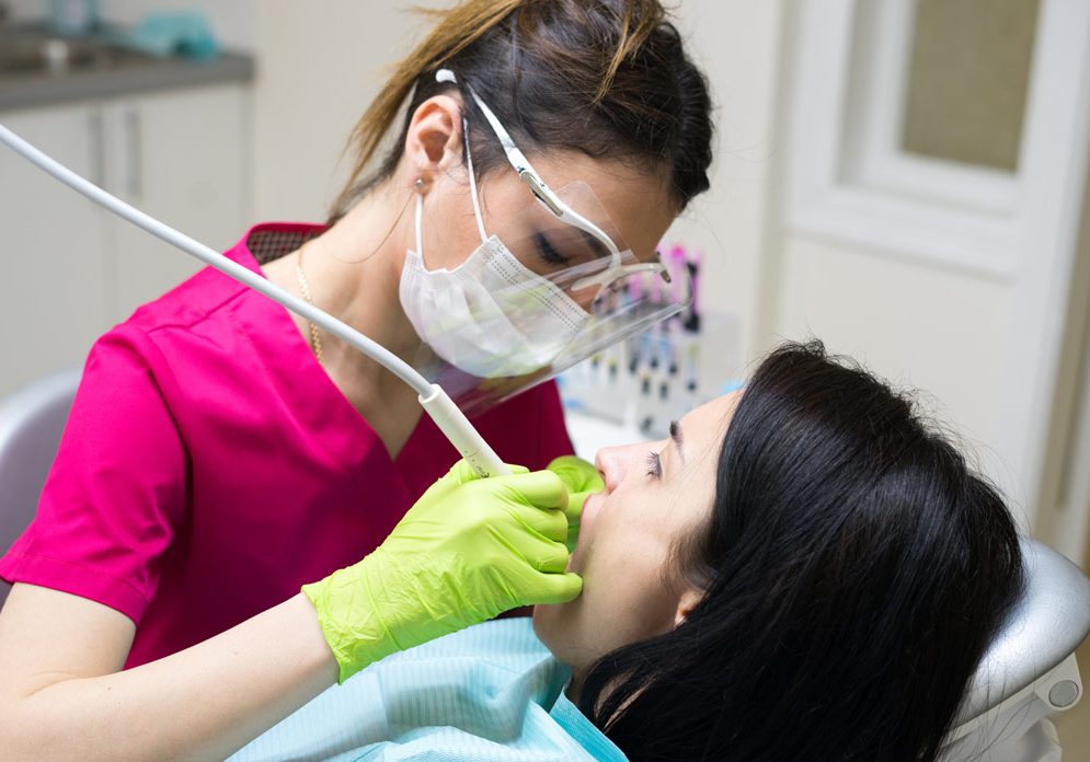 dentist-cleaning-teeth-of-woman